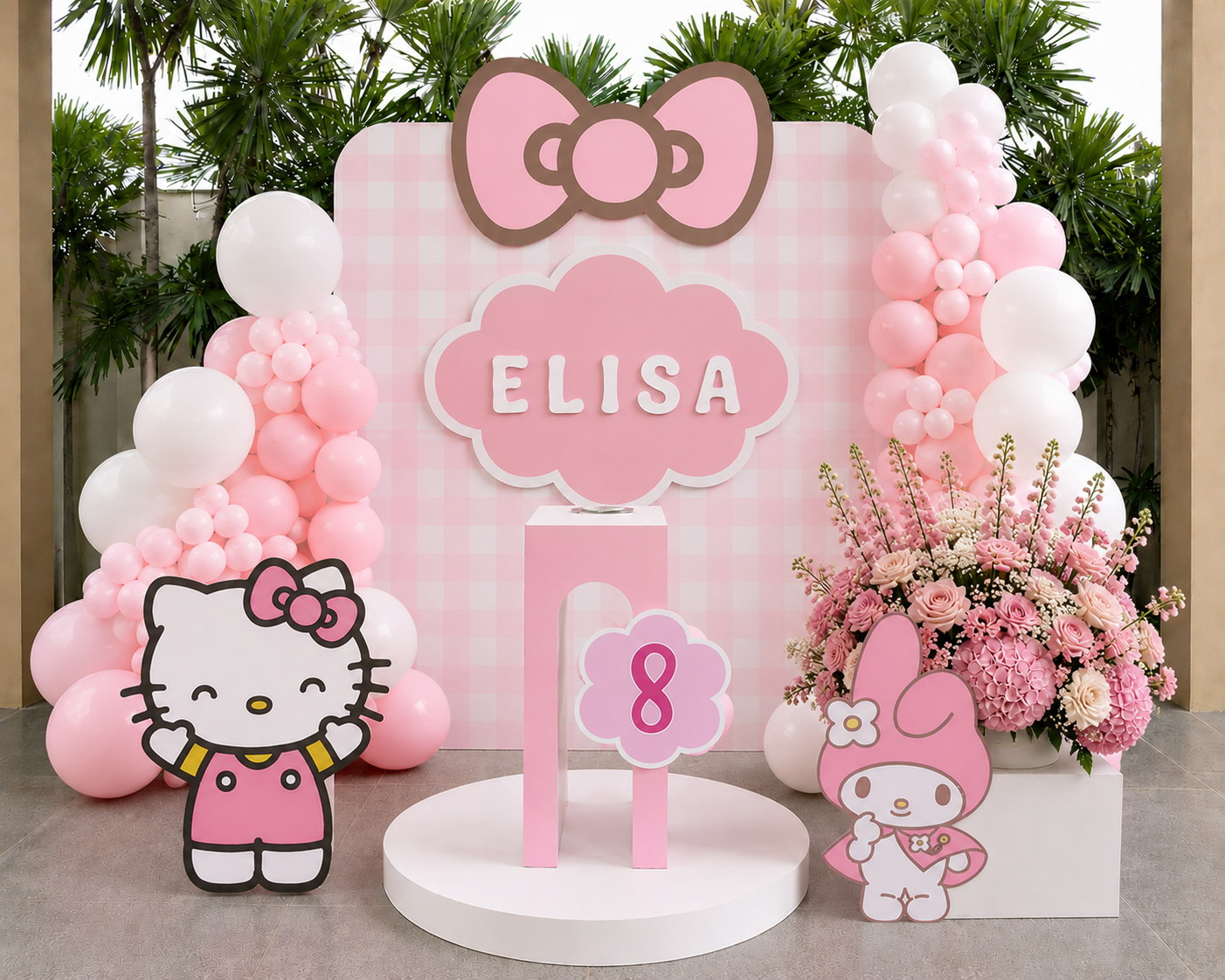 Hello Kitty themed birthday backdrop with pink balloons, character cut-outs and a personalised name sign