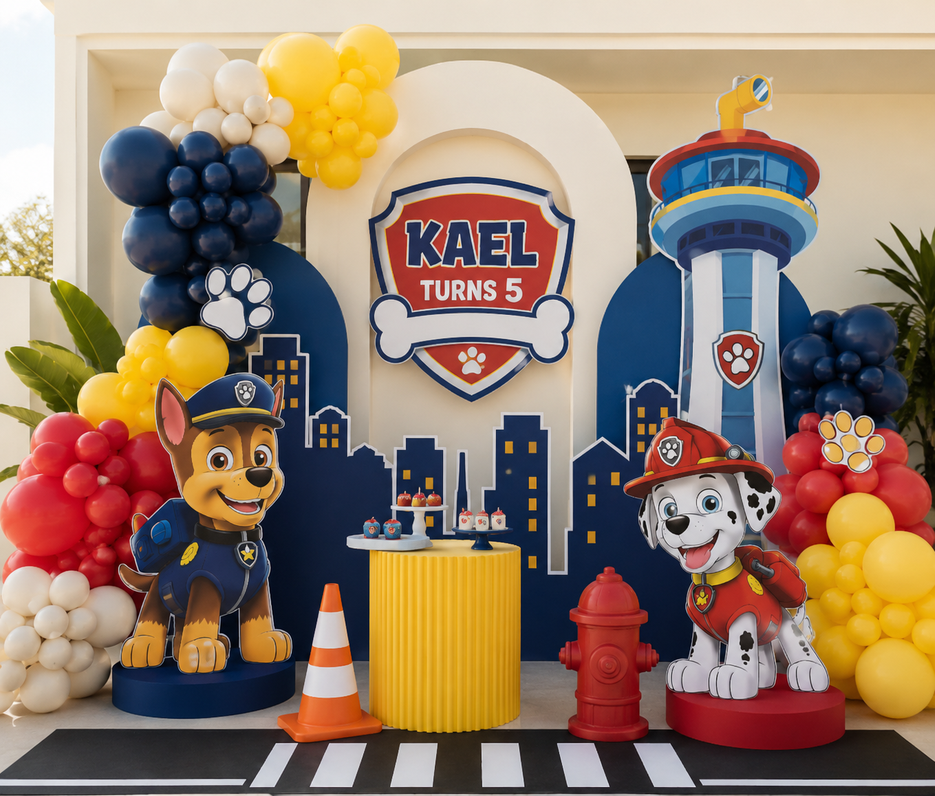 Paw Patrol themed birthday backdrop with character cut-outs, balloons and personalised signage