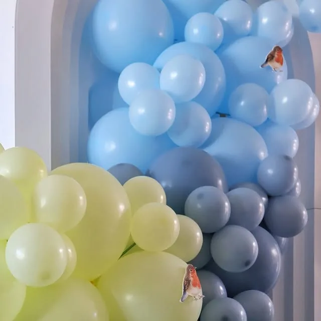 Layered blue and soft green balloon installation